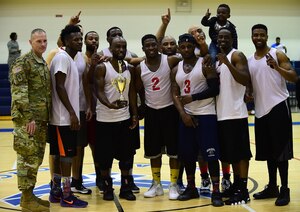 U.S. Army Col. Herbert Joliat, 633rd Air Base Wing incoming vice commander, poses with the winning team, the Ryan Center, after the 2016-2017 intramural basketball championship game at Joint Base Langley-Eustis, Va., Feb. 22, 2017. The team defeated the 633rd Force Support Squadron, after losing to them in the championship the prior year. (U.S. Air Force photo by Senior Airman Kimberly Nagle) 