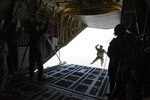 A U.S. Air Force combat controller from the 353rd Special Operations Group, Kadena Air Base, Japan exits a C-130J Super Hercules during a free-fall jump with India Special Forces paratroopers during Aero India 2017 at Air Force Station Yelahanka, Bengaluru, India, Feb. 16, 2017. Jumpers from the two countries shared best practices and combined into jump teams, to the delight of the crowd. The U.S. participates in air shows and other regional events to demonstrate its commitment to the security of the Indo-Asia-Pacific region, promote the standardization and interoperability of equipment, and display capabilities critical to the success of current and future military operations.