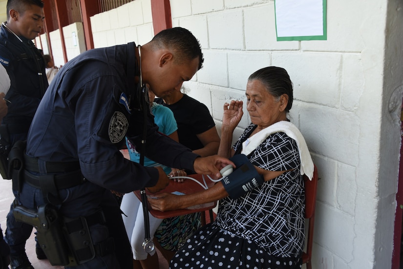 A police officer with the San Pedro Sula Metropolitan Police Unit Medical Brigade conducts a medical assessment during a medical civic action program mission in San Pedro Sula, Honduras, Feb. 18. Approximately 1,175 patients were seen in this one-day collaboration effort between local police, JTF-Bravo, local providers and private organizations. Working with Honduran police forces on joint exercises solidifies JTF-Bravo as a Partner-of-Choice for collaborative actions.