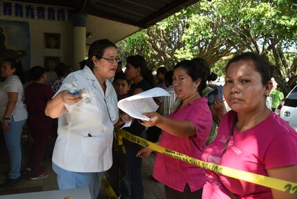 Colonel (Dr.) Douglas Lougee, MEDEL Commander and pediatrician, conducts a medical assessment of a young family during a medical civic action program mission in San Pedro Sula, Honduras, Feb. 18. Approximately 1,175 patients were seen in this one-day collaboration effort between local police, JTF-Bravo, local providers and private organizations. Working with Honduran police forces on joint exercises solidifies JTF-Bravo as a Partner-of-Choice for collaborative actions.