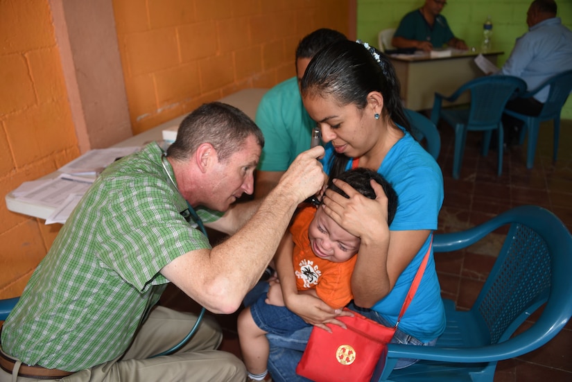 Colonel (Dr.) Douglas Lougee, MEDEL Commander and pediatrician, conducts a medical assessment of a young family during a medical civic action program mission in San Pedro Sula, Honduras, Feb. 18. Approximately 1,175 patients were seen in this one-day collaboration effort between local police, JTF-Bravo, local providers and private organizations. Working with Honduran police forces on joint exercises solidifies JTF-Bravo as a Partner-of-Choice for collaborative actions.