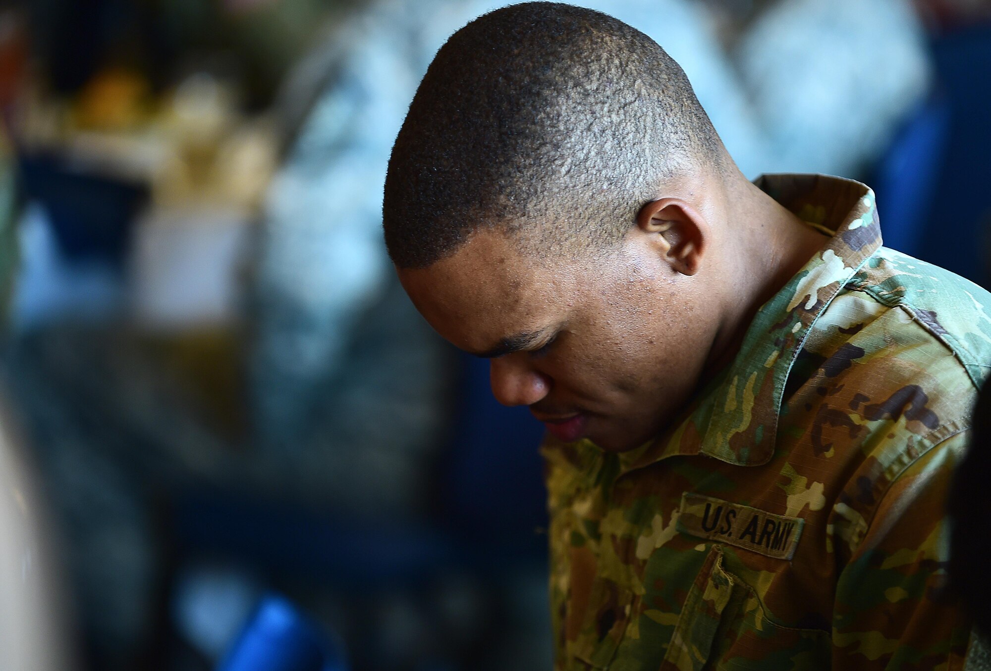 A U.S. Army Soldier bows his head in prayer during the National Prayer Luncheon at Joint Base Langley-Eustis, Va., Feb. 22, 2017. During the ceremony, both U.S. Army Soldiers and U.S. Air Force Airmen gathered in honor of the annual event. (U.S. Air Force photo by Senior Airman Kimberly Nagle)