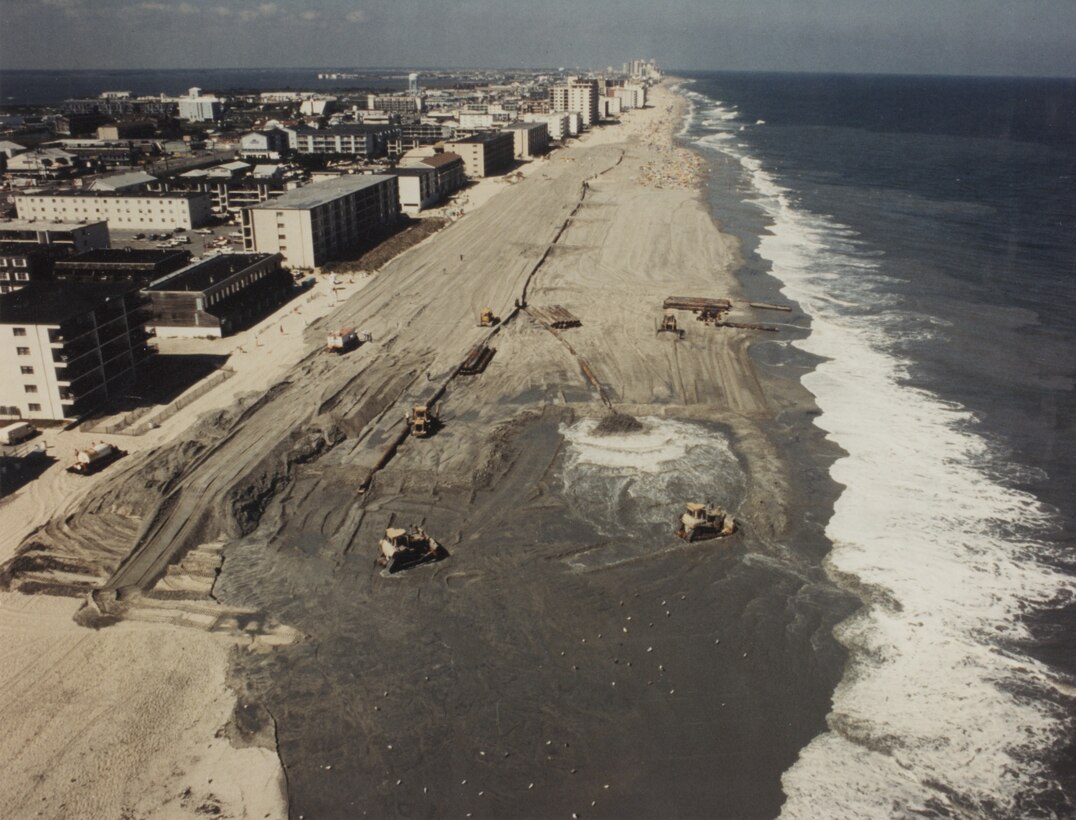 Sand is pumped onto the beach at Ocean City in 1991 as part of initial construction of the beach berm and dune that are parts of the existing coastal storm risk management project. The Corps of Engineers, working closely with the state of Maryland and Ocean City, has continued to maintain the project over the years, and it has prevented an estimated nearly $1 billion in damages since initial construction.