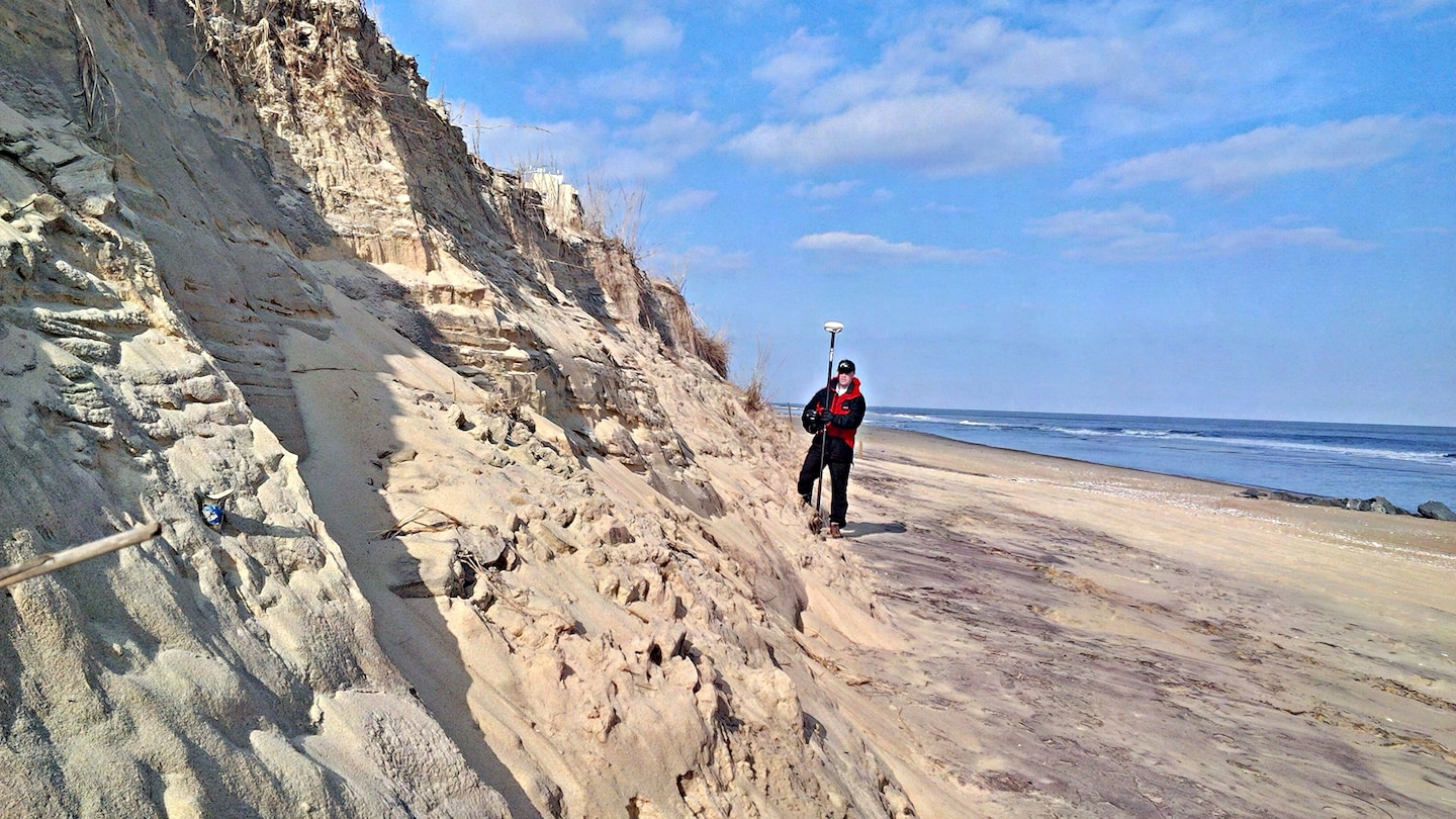 Thomas Laczo, hydraulic engineer for the U.S. Army Corps of Engineers, Baltimore District, assesses impacts on a sand dune in Ocean City, Maryland, as part of a team conducting post-storm damage assessments of the Atlantic Coast of Maryland Shoreline Protection Project Jan.27, 2016 after a powerful winter storm nicknamed “Winter Storm Jonas.” The dune and beach berm in front of it provide a buffer to help reduce the impacts of coastal storms on homes and infrastructure behind the berm and dune system.