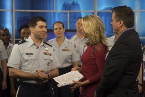 Capt. Daniel Booth, U.S. Air Force Band assistant director of operations and associate conductor, speaks with Bob Frier and Amy Kaufeldt, co-hosts of 'Good Day Orlando', in Lake Mary, Fla., Feb. 21, 2017. During the broadcast the ensemble performed snippets of patriotic music from their program and gave an overview of their weeklong tour. (U.S. Air Force Photo by Airman 1st Class Rustie Kramer)