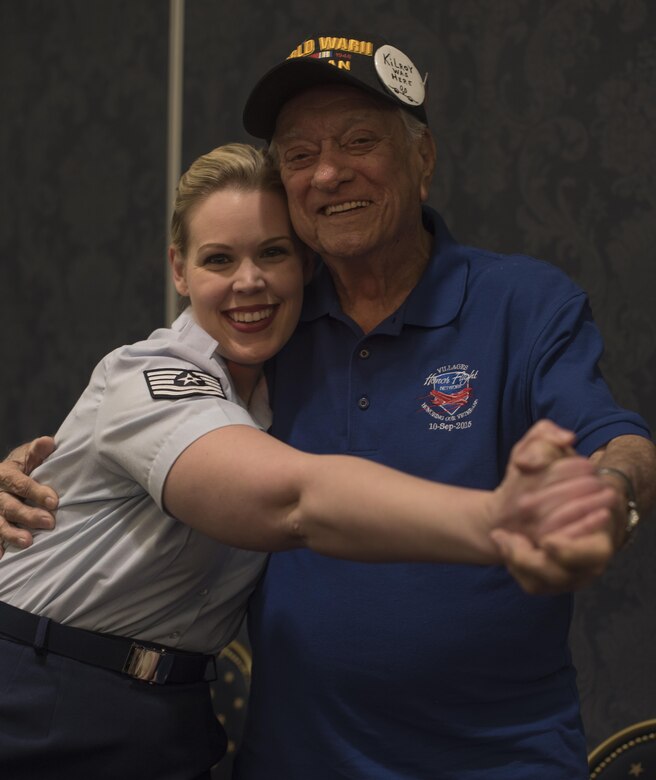 Tech. Sgt. Ashley Keeks, U.S. Air Force Band Singing Sergeants ensemble soprano vocalist, poses with Harry Maass, audience member, after a show at the Eisenhower Recreational Center in The Villages, Fla., Feb. 22, 2017. After performing a variety of musical hits from the 1940s and '50s, members of the Singing Sergeants met with local veterans and received a tour of the center. The facility has numerous displays of historical military memorabilia donated by veterans and their families. (U.S. Air Force photo by Airman 1st Class Rustie Kramer)