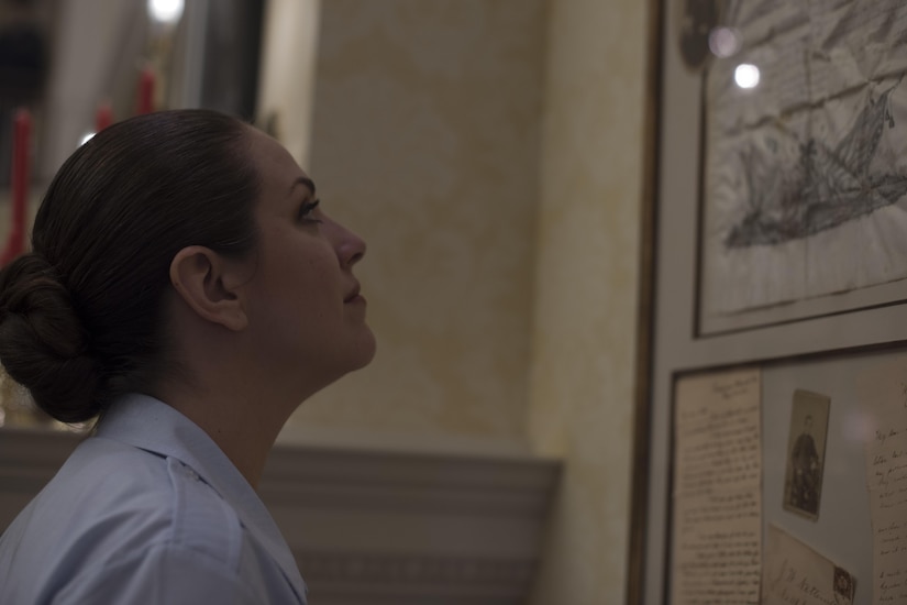 Tech. Sgt. Julia Cuevas, U.S. Air Force Band Singing Sergeants ensemble alto vocalist, examines a document signed by Abraham Lincoln at the Eisenhower Regional Recreational Center in The Villages, Fla., Feb. 22, 2017. The Singing Sergeants performed a variety of musical hits from the 1940s and '50s for audience members before receiving a tour of the center. The facility has numerous displays of historical military memorabilia donated by veterans and their families. (U.S. Air Force Photo by Airman 1st Class Rustie Kramer)