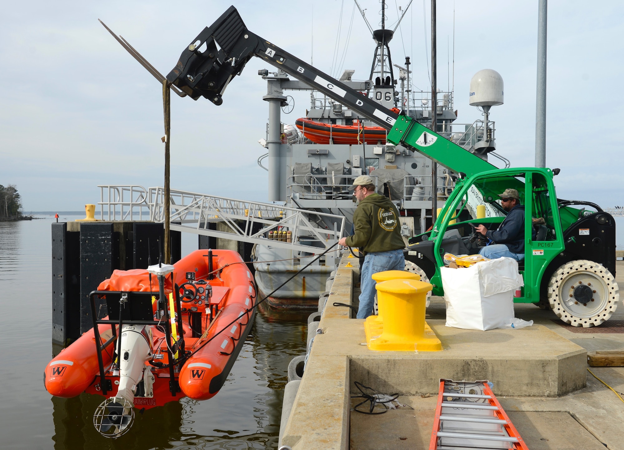Third Port personnel lower a Ridged Hall Inflatable Boat into the water at Joint Base Langley-Eustis, Va., Feb. 22, 2017. The port houses U.S. Army vessels in the harbor, for training and operational use. (U.S. Air Force photo by Airman 1st Class Kaylee Dubois)