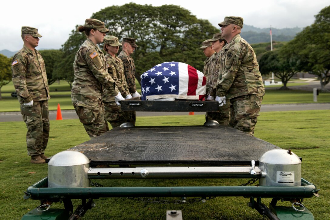 Members of the honor guard detail for the Defense POW/MIA Accounting Agency carry the casket of an unknown service member during a disinterment ceremony at the National Memorial Cemetery of the Pacific in Honolulu, Feb. 27, 2017. The disinterred remains will go to the agency's laboratory for identification. The agency's mission is to provide the fullest possible accounting of U.S. missing personnel to their families and the nation. Navy photo by Petty Officer 3rd Class Armando Velez