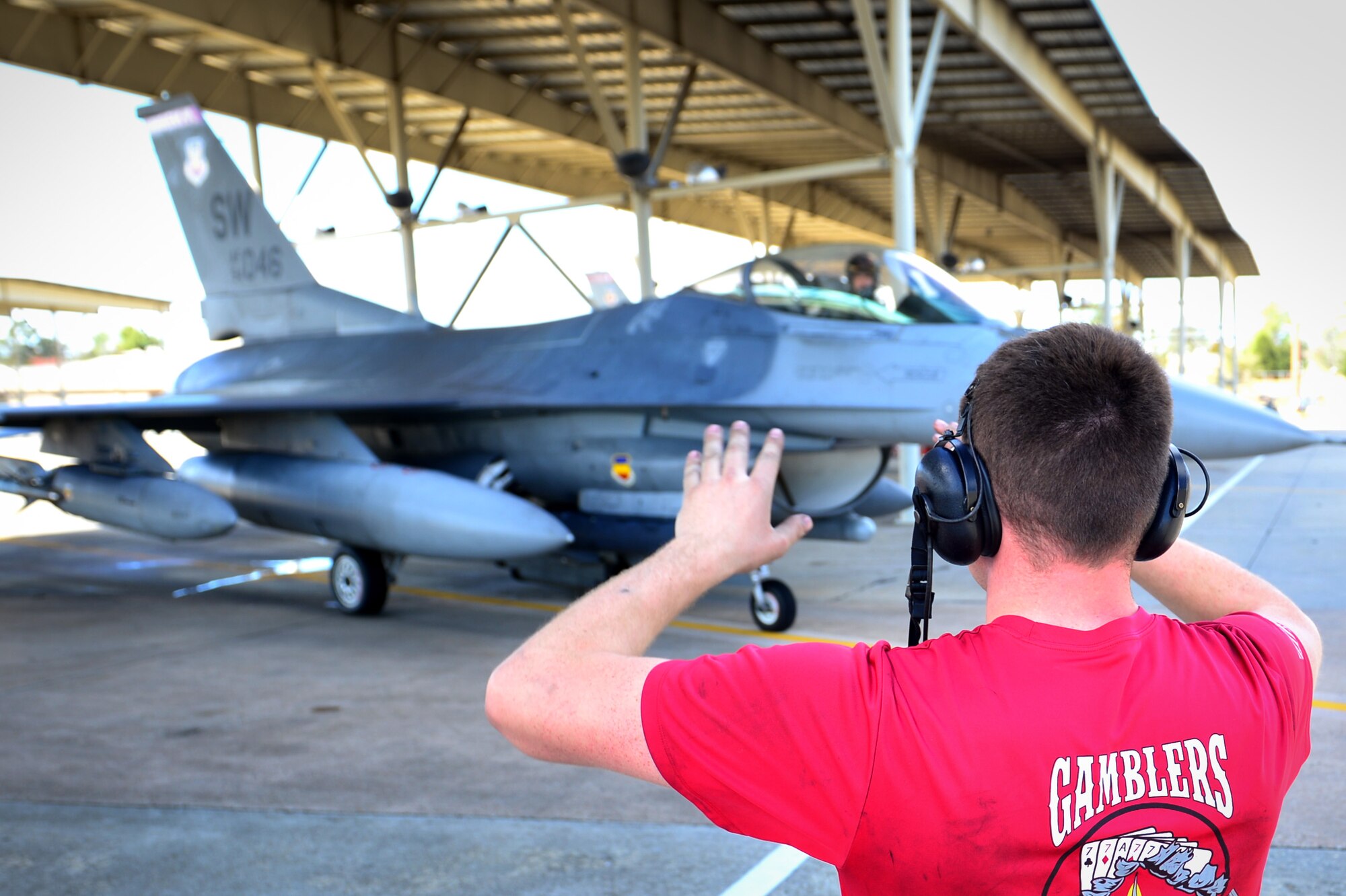 U.S. Air Force Senior Airman Jay Lenoble, 20th Aircraft Maintenance Squadron tactical aircraft maintainer, marshals an F-16CM Fighting Falcon at Shaw Air Force Base, S.C., Feb. 24, 2017. Team Shaw pilots will use the aircraft during Red Flag 17-2 at Nellis AFB, Nev., scheduled to take place Feb. 27 to March 10. Airmen will gain experience suppressing enemy air defenses by dropping live ordnances at a training range. (U.S. Air Force photo by Airman 1st Class Christopher Maldonado)