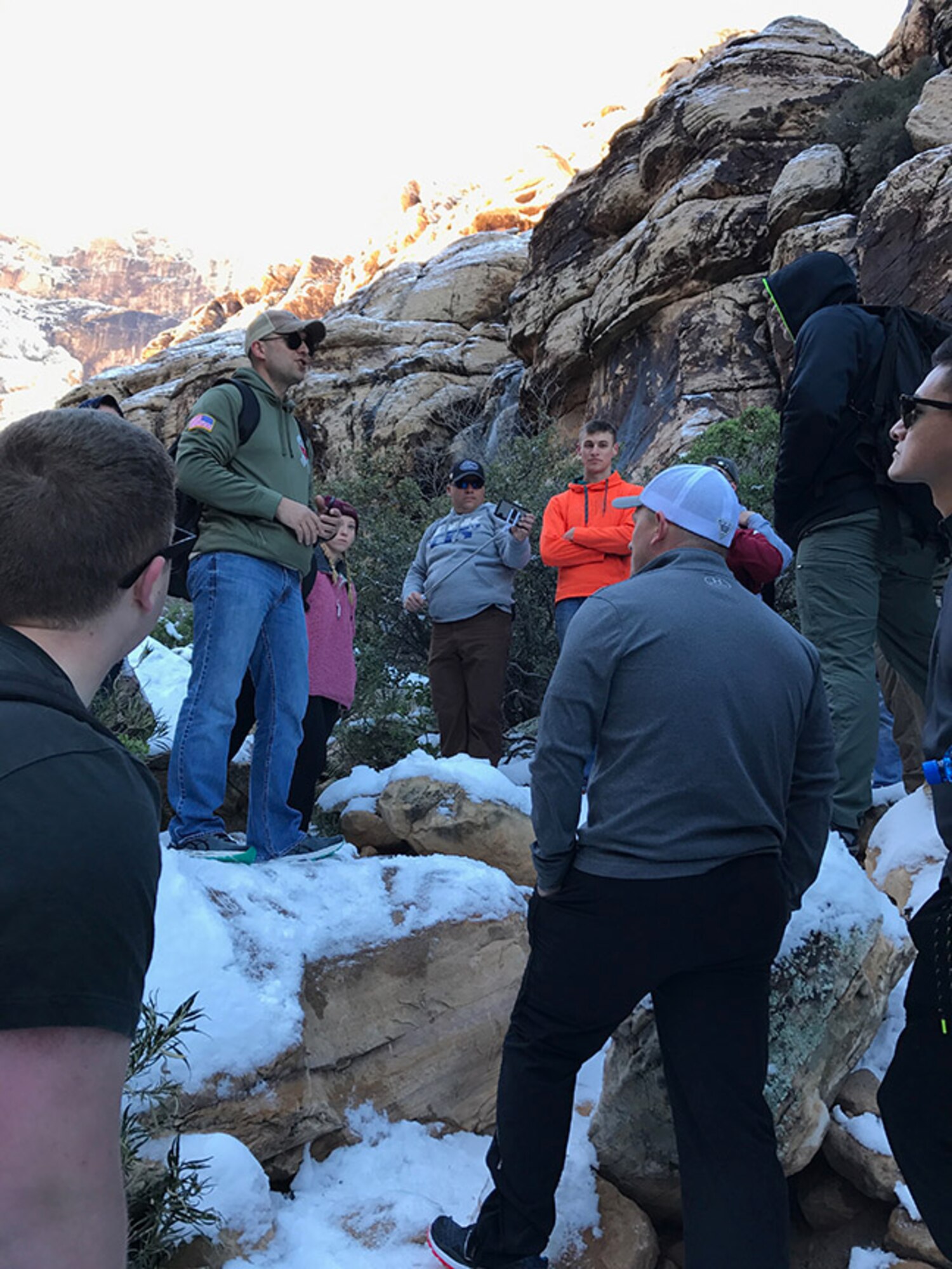 Chaplain (1st Lt.) Gerald Stout, 23d Wing chaplain, talks to 23d Maintenance Group Airmen during a resiliency hike as a part of Green-Flag West 17-03, Jan. 30, 2017, at Red Rock, Nev. During their visit, Moody’s chapel team interacted with approximately 200 Airmen as they completed 55 sorties over 130 man hours during their visit. (Courtesy photo)
