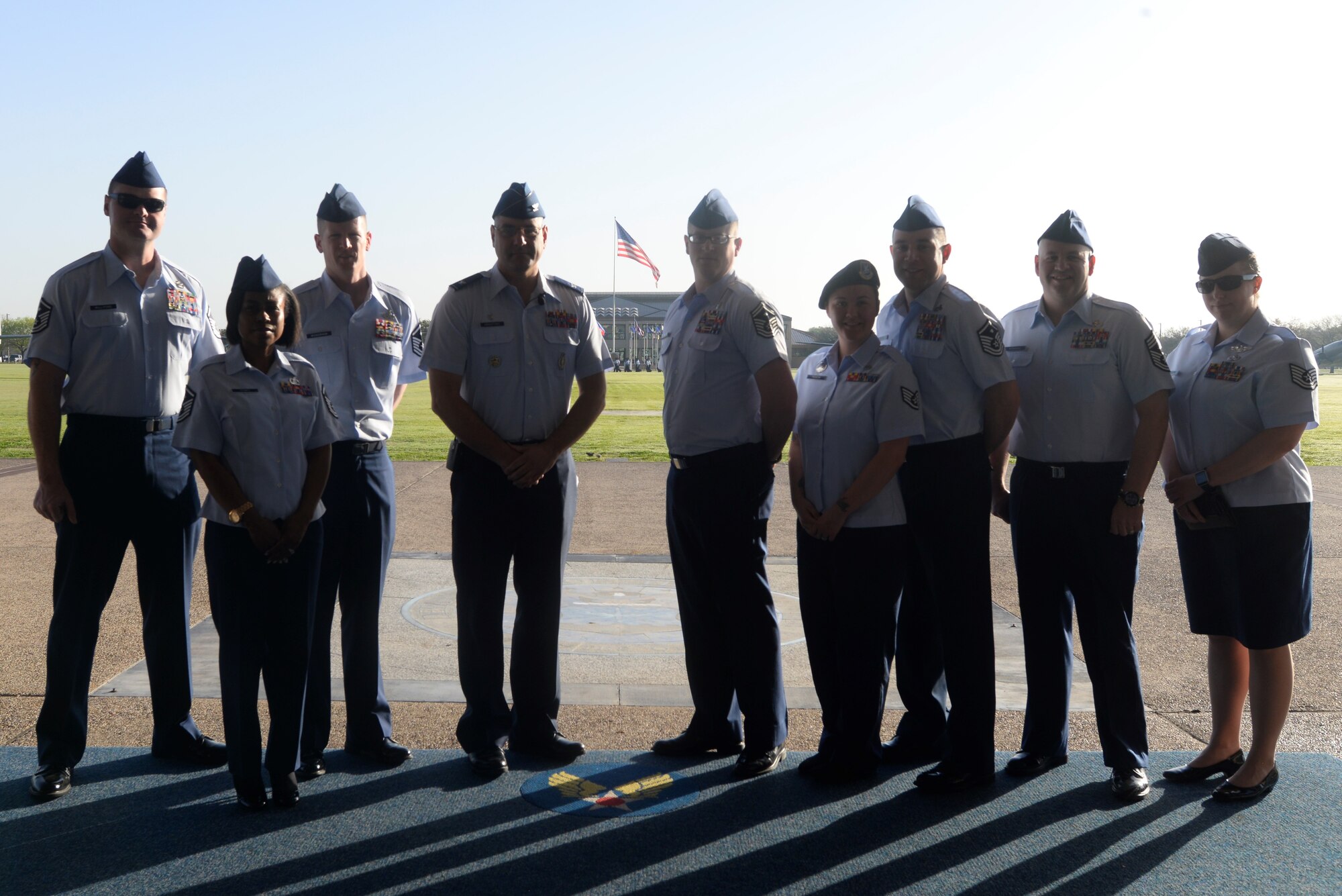 Col. Stephen Kravitsky, 90th Missile Wing commander, Chief Master Sgt. Jeffery Steagall, 90th Missile Wing command chief, and a group of noncommissioned officers from F.E. Warren Air Force Base, Wyo., stand together on the reviewing stand before the Basic Military Training Graduation Parade at Lackland AFB, Texas, Feb. 24. The group participated in a two-day tour of BMT, attended the Airman’s Run, Coining Ceremony and Graduation Parade as well as tours of the newest training facilities on the installation. (U.S. Air Force Photo by 1st Lt Esther Willett)