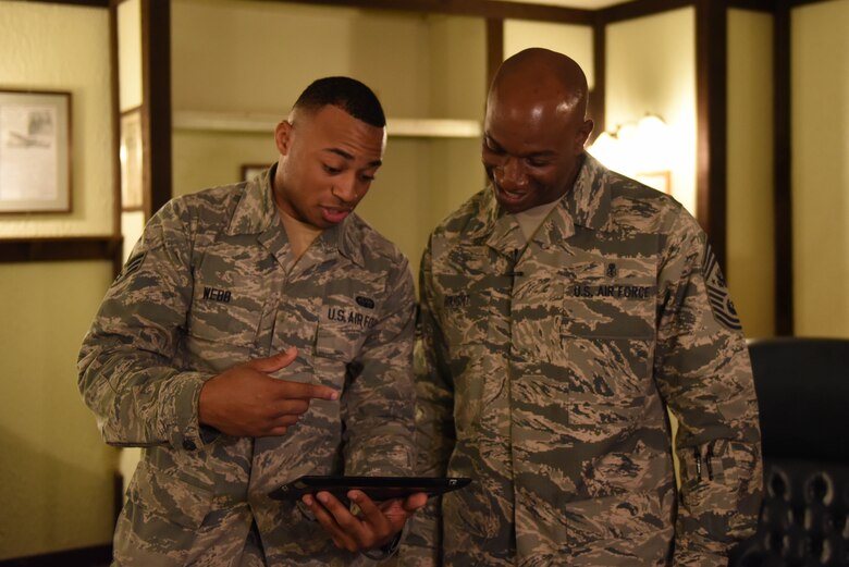 Chief Master Sgt. of the Air Force Kaleth O.  Wright tests his microphone with Senior Airman Exzavior Webb, 2nd Communications Squadron radio frequency transmissions, before his all call at Barksdale Air Force Base, La., Feb. 22, 2017. Barksdale is the first base Wright visited since being named Chief Master Sergeant of the Air Force. (U.S. Air Force Photo/Airman 1st Class Stuart Bright)