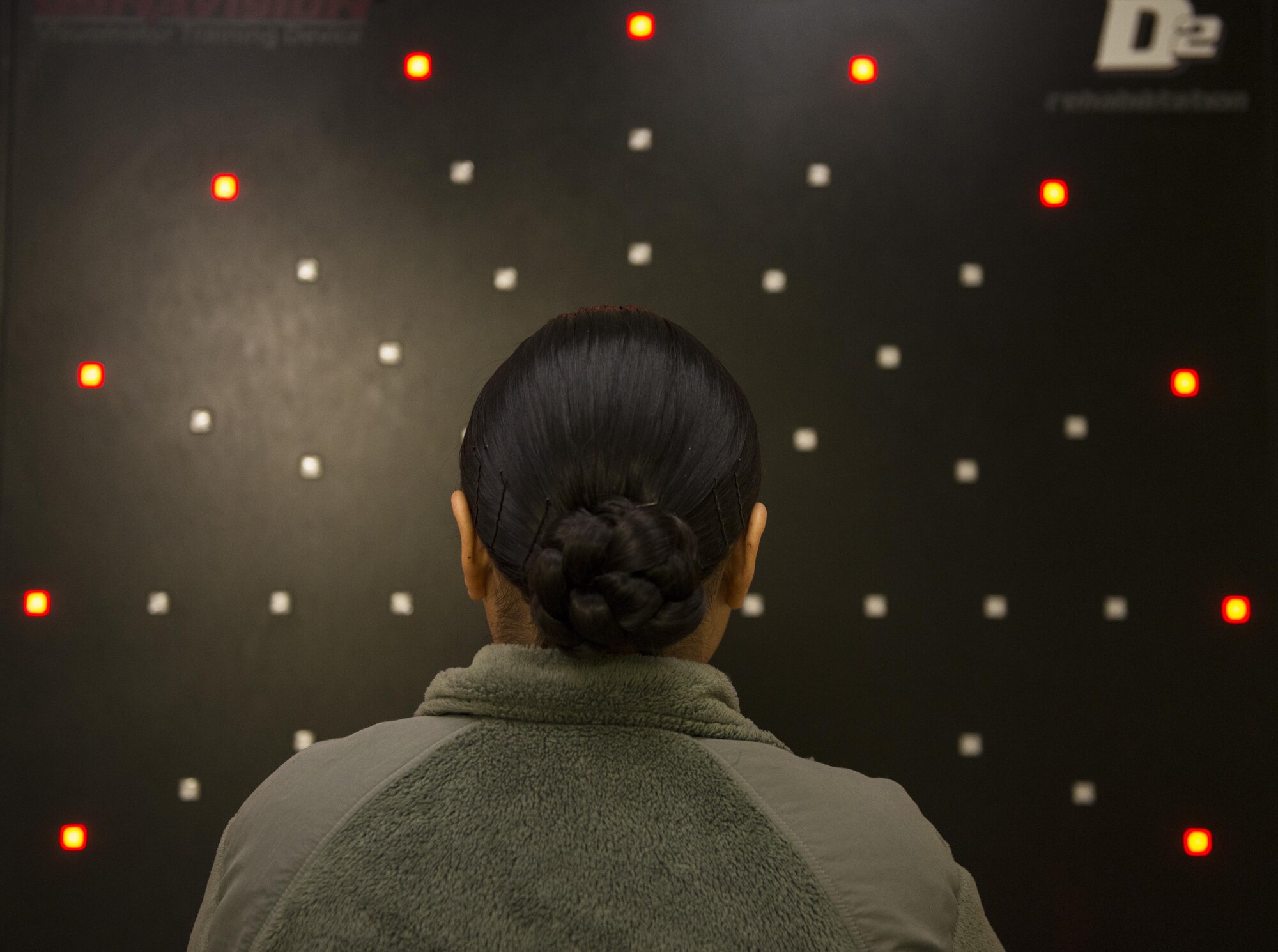 An Airman waits for the Dynavision D2 to load at the Traumatic Brain Injury Clinic at Joint Base Elmendorf-Richardson, Alaska, Feb. 28, 2017. The Dynavision is used to improve cognitive processing, balance and functional mobility.