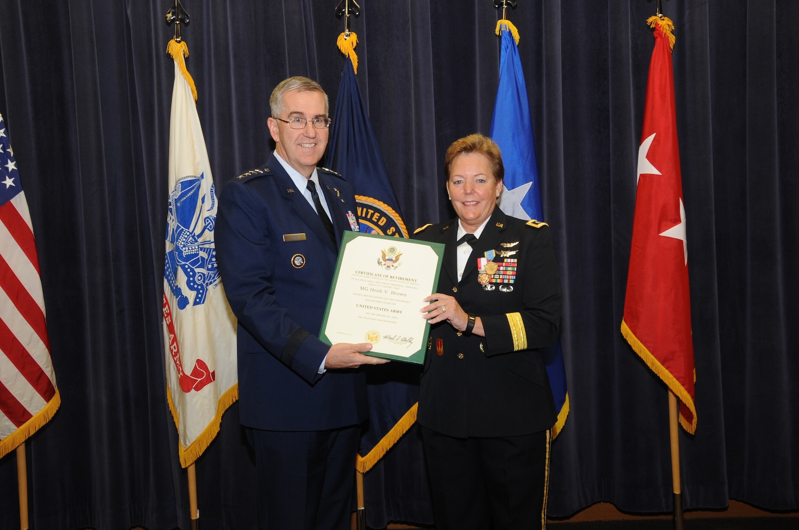 U.S. Air Force Gen. John E. Hyten, commander of U.S. Strategic Command (USSTRATCOM), presents the Certificate of Retirement to U.S. Army Maj. Gen. Heidi V. Brown, USSTRATCOM director of global operations, during a ceremony in the 557th Weather Wing auditorium, Offutt Air Force Base, Neb., Feb. 24, 2017. Brown served more than 35 years in the U.S. Army and will effectively retire Apr. 1, 2017.  Brown holds many distinctions, including the first woman to command and lead a U.S. Army brigade into combat, the first female general in the U.S. Army Air Defense Artillery Branch, the senior female combat arms officer in the Army, the first female combatant command operations director and the first soldier to serve as USSTRATCOM director of global operations.  Brown arrived at USSTRATCOM in February 2015, after serving as Missile Defense Agency’s test director at Fort Belvoir, Md.  One of nine DoD unified combatant commands, USSTRATCOM has global strategic missions assigned through the Unified Command Plan that include strategic deterrence; space operations; cyberspace operations; joint electronic warfare; global strike; missile defense; intelligence, surveillance and reconnaissance; and analysis and targeting.
