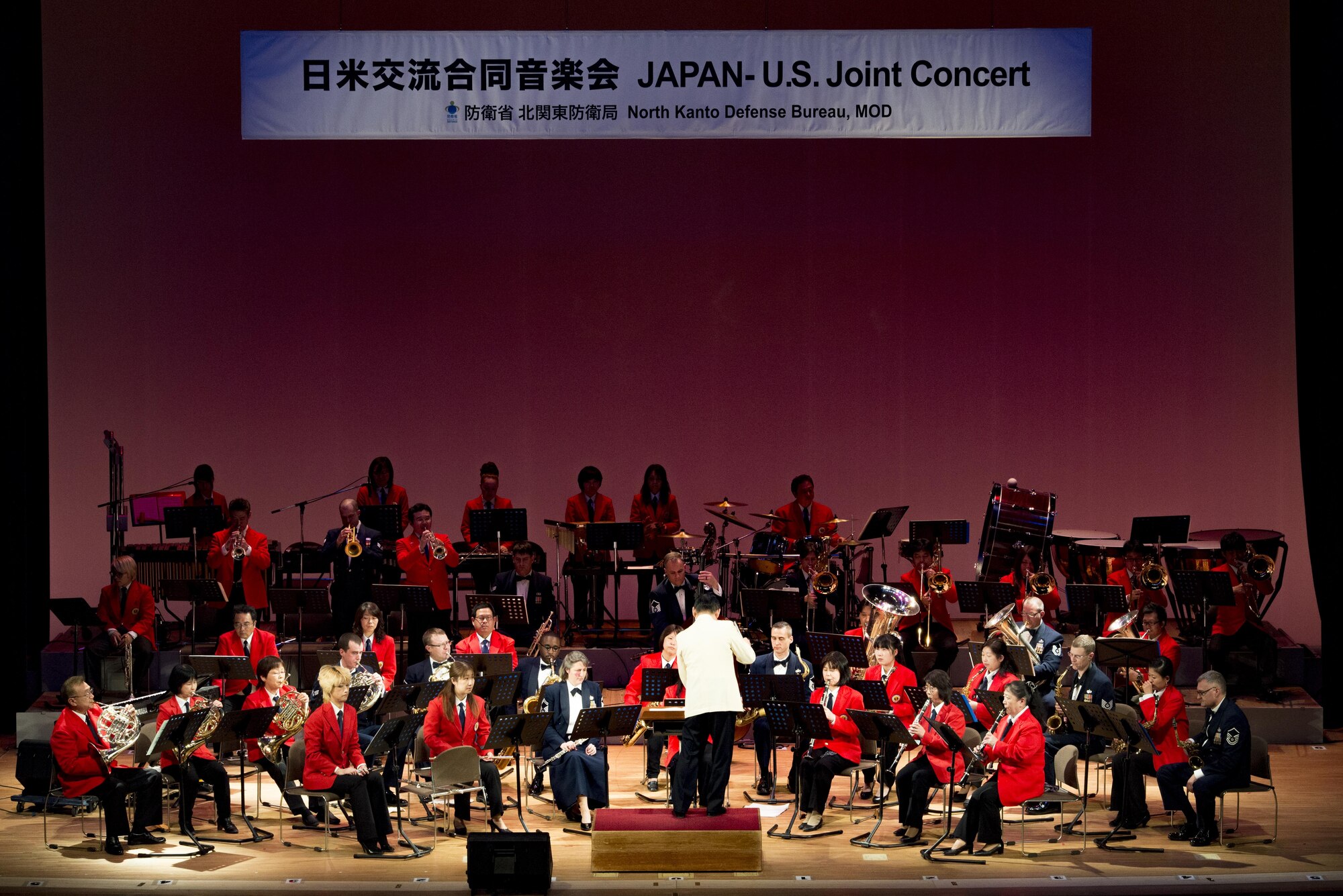 Hisatoshi Muta conducts the Mizuho Youth Symphonic Band and the U.S. Air Force Band of the Pacific-Asia, as they perform together on stage during the Japan-U.S. Joint Concert Feb. 18, 2017, at the Mizuho View Park Sky Hall in Mizuho, Tokyo, Japan. The Mizuho Youth Symphonic Band and the U.S. Air Force Band of the Pacific-Asia mixed and played as one for the event. (U.S. Air Force photo by Airman 1st Class Donald Hudson)