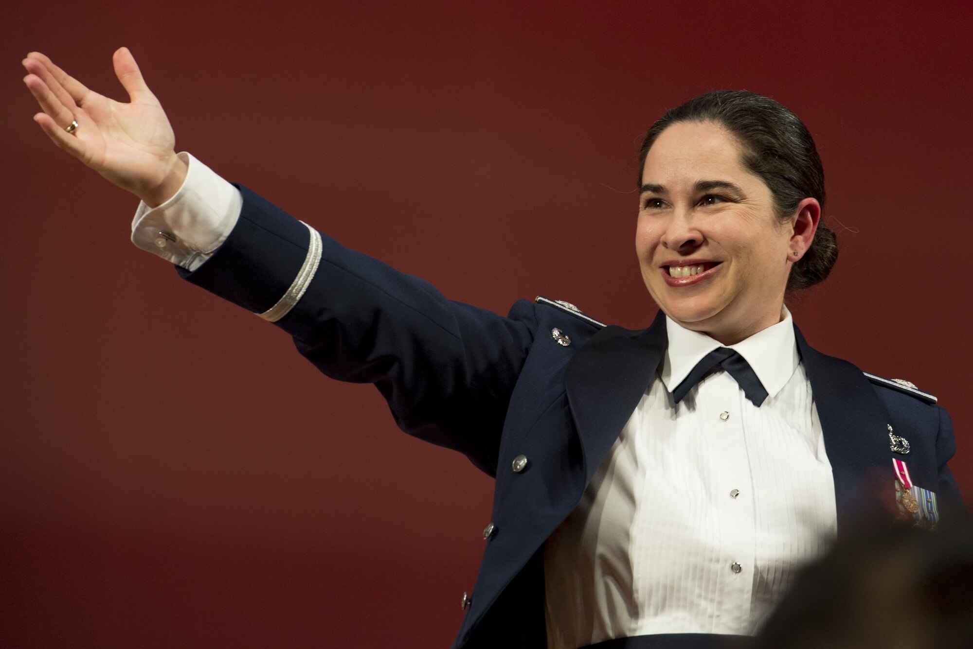 Lt. Col. Cristina Moore Urrutia, U.S. Air Force Band of the Pacific-Asia commander and conductor, encourages the audience to clap for Hisatoshi Muta, Mizuho Youth Symphonic Band conductor, after performance during the Japan-U.S. Joint Concert Feb. 18, 2017, at the Mizuho View Park Sky Hall in Mizuho, Tokyo, Japan. The Mizuho Youth Symphonic Band and the U.S. Air Force Band of the Pacific-Asia mixed and played as one for the event. (U.S. Air Force photo by Airman 1st Class Donald Hudson)