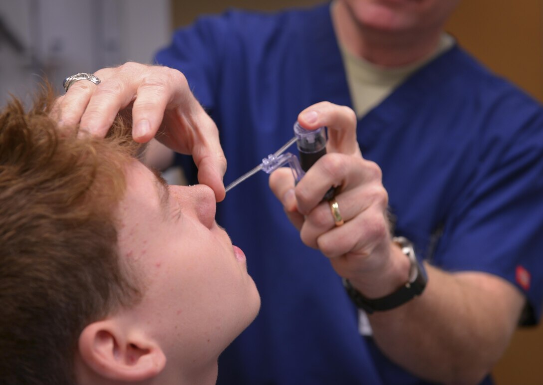 Lt. Col. Chester Barton, 374th Ear Nose and Throat Clinic otolaryngologist, examines Guy Chad Schuch Jr., Yokosuka Naval Base high school student, for nasal damage at Yokota Air Base, Japan, Feb. 16, 2017. The Yokota ENT clinic is the only U.S. Air Force ENT clinic in Japan and regularly supports surrounding bases with everything from aching heads to broken faces. (U.S. Air Force photo by Senior Airman Elizabeth Baker)