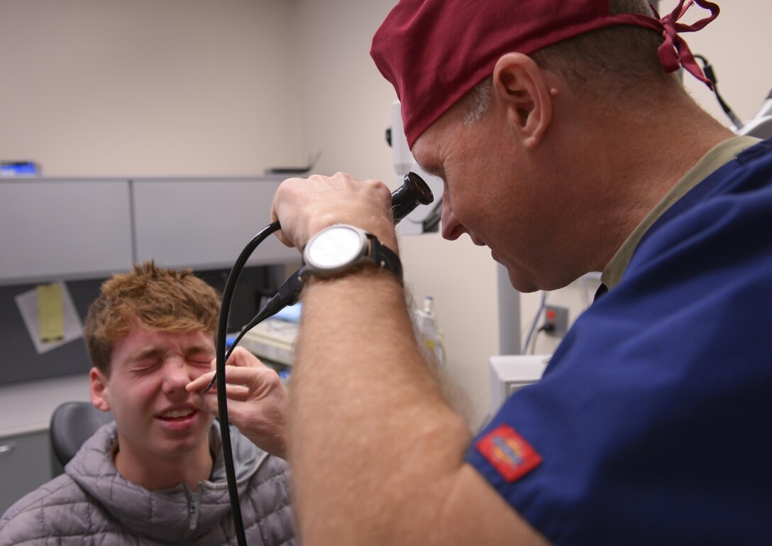 Lt. Col. Chester Barton, 374th Ear Nose and Throat Clinic otolaryngologist, examines Guy Chad Schuch Jr., Yokosuka Naval Base high school student, for nasal damage at Yokota Air Base, Japan, Feb. 16, 2017. The Yokota ENT clinic is the only U.S. Air Force ENT clinic in Japan and regularly supports surrounding bases with everything from aching heads to broken faces. (U.S. Air Force photo by Senior Airman Elizabeth Baker)