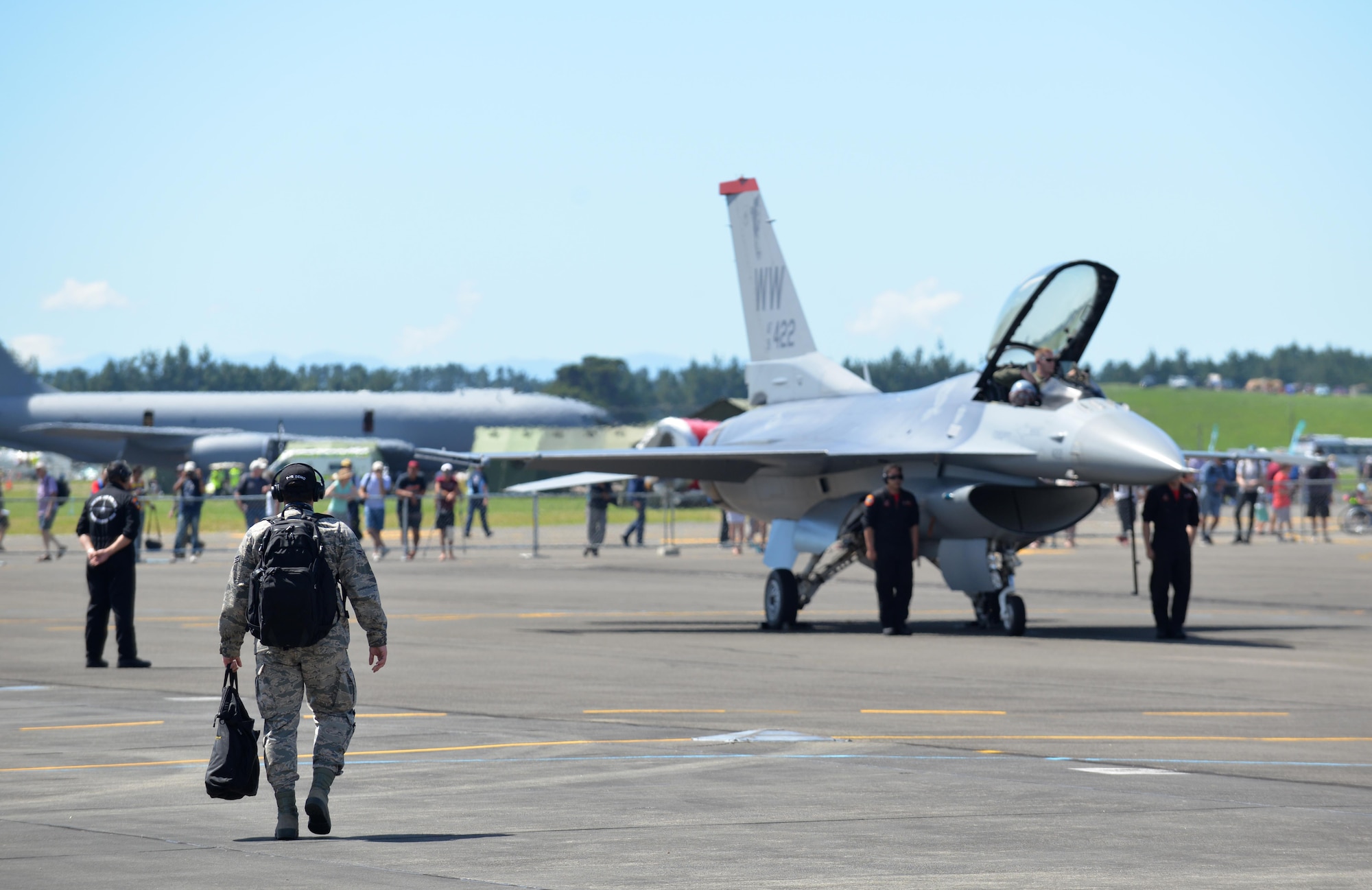 A Misawa Airman approaches as crew chiefs perform a ground show after Maj. Richard Smeeding's air demonstration at Royal New Zealand Air Force Base Ohakea, New Zealand, Feb. 24, 2017. Smeeding is the demo team pilot who performed two shows during the RNZAF's 2017 Air Tattoo. The F-16 was one of 64 aircraft exhibited during the show and one of 50 to offer an air display. (U.S. Air Force photo by Senior Airman Jarrod Vickers)