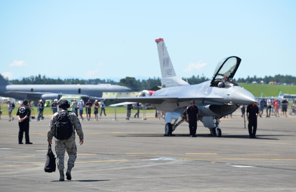 A Misawa Airman approaches as crew chiefs perform a ground show after Maj. Richard Smeeding's air demonstration at Royal New Zealand Air Force Base Ohakea, New Zealand, Feb. 24, 2017. Smeeding is Pacific Air Forces' Demo Team pilot who performed two shows during the RNZAF's 2017 Air Tattoo. The F-16 was one of 64 aircraft exhibited during the show and one of 50 to offer an air display. (U.S. Air Force photo by Senior Airman Jarrod Vickers)