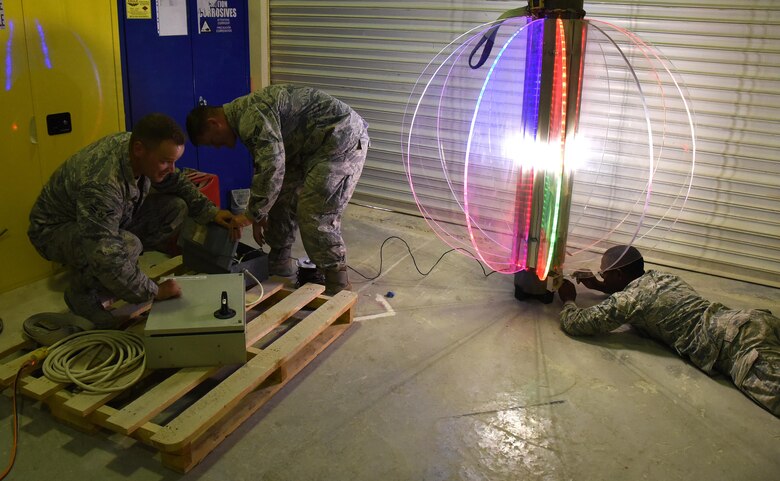 U.S. Air Force Airmen with the 379th Expeditionary Civil Engineer Squadron work on a New Year’s Eve light up ball that their unit repaired at Al Udeid Air Base, Qatar, Dec. 21, 2016. With the hope of spreading holiday cheer, the 379th ECES will be lowering this ball in celebration of the new year.  (U.S. Air Force photo by Senior Airman Cynthia A. Innocenti)