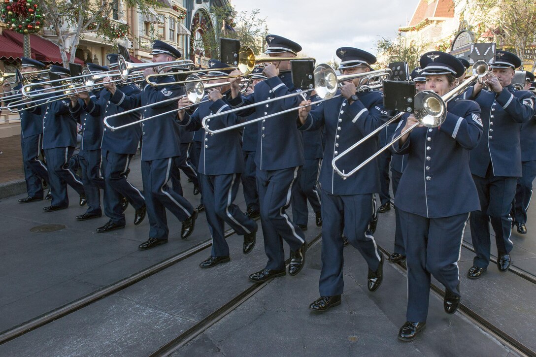 Musicians from the United States Air Force Total Force Band march down Main Street in Disneyland during a Retreat Ceremony in Anaheim, Calif., Jan. 1, 2017. The band is comprised of active duty and Air National Guard musicians from around the Air Force. Air Force photo by Louis Briscese