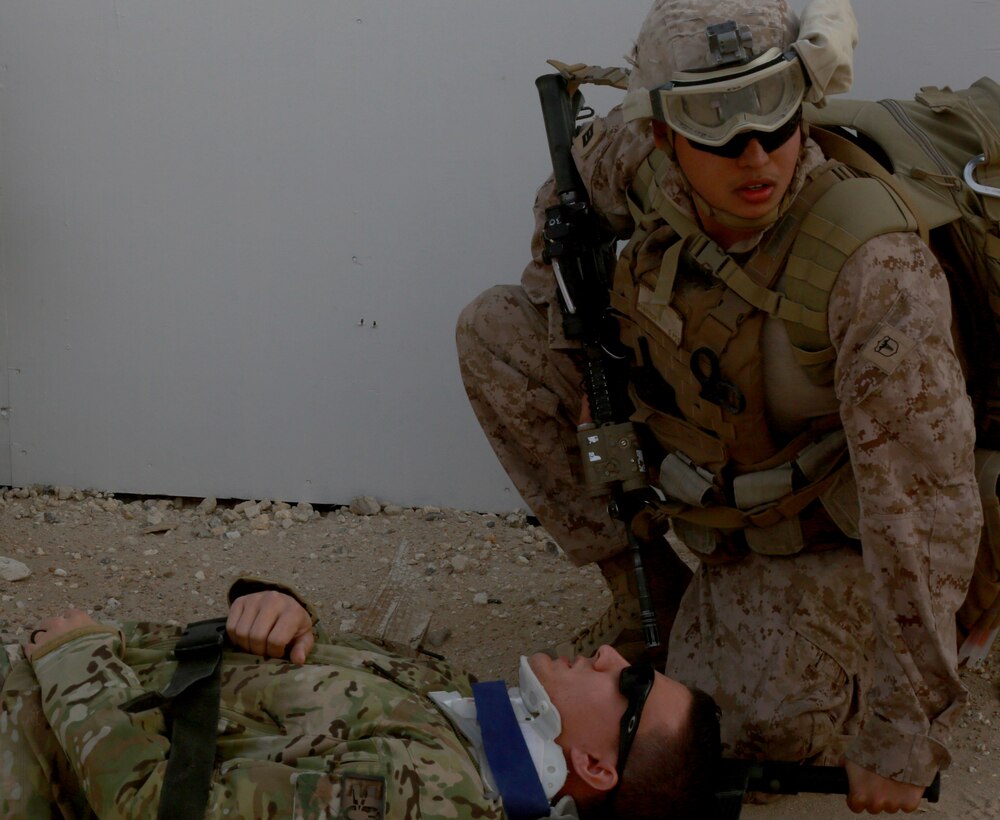 U.S. Navy Seaman Andrew Robertson, Corpsman with Special Purpose Marine Air-Ground Task Force-Crisis Response-Central Command, watches over the simulated isolated personnel during a Tactical Recovery of Aircraft and Personnel exercise, while forward deployed to the Middle East, Dec. 26, 2016. SPMAGTF Marines consistently train to enhance their ability to react to any mission they may encounter while conducting USCENTCOM’s crisis response mission. (U.S. Marine Corps photo by Lance Cpl. Christopher D. Thompson)
