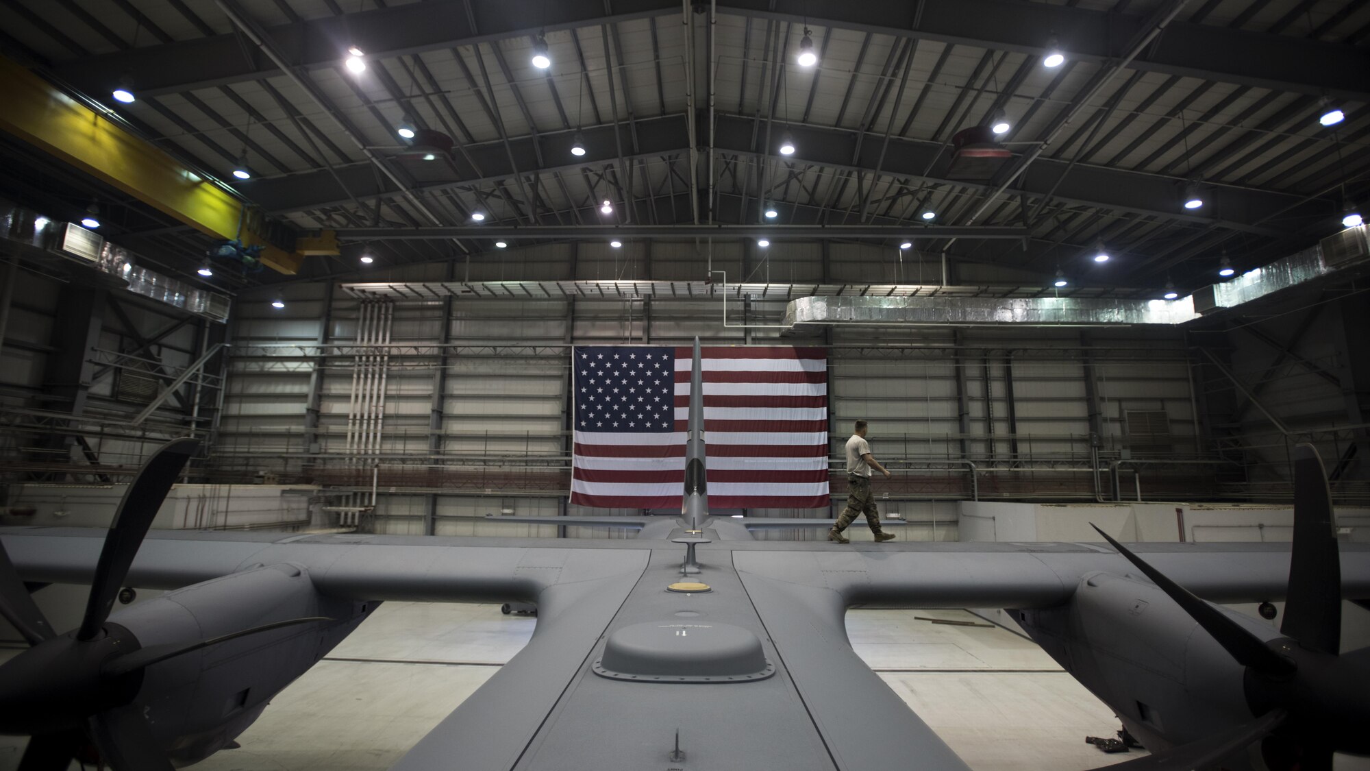 Staff Sgt. Kyle Pringle, 455th Expeditionary Aircraft Maintenance Squadron crew chief, walks on top of a C-130J Hercules during an inspection Dec. 5, 2016 at Bagram Airfield, Afghanistan. The C-130 aircraft maintenance unit component of the 455th EAMXS is responsible for upkeep and repair of Bagram’s fleet of C-130J aircraft. (U.S. Air Force photo by Staff Sgt. Katherine Spessa)