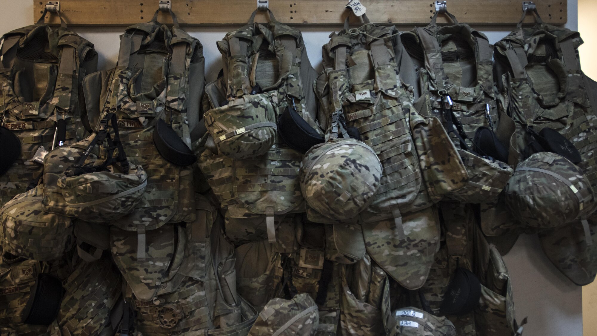 Interceptor body armor belonging to members of the 455th Expeditionary Aircraft Maintenance Squadron hangs from hooks in the C-130J Hercules aircraft maintenance unit Dec. 9, 2016 at Bagram Airfield, Afghanistan. Each member must have IBA readily available in case of indirect fire attacks. (U.S. Air Force photo by Staff Sgt. Katherine Spessa)