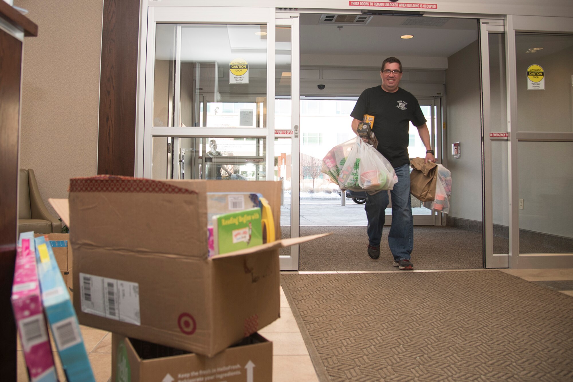 COLORADO SPRINGS, Colo. - Tech. Sgt. Thomas Echelmeyer, 5/6 Club president from Peterson Air Force Base, Colo., drops off toys at the Pediatric Center for Cancer and Blood Disorders at Children's Hospital Colorado, Dec. 19, 2016, in Colorado Springs, Colo. This year the 5/6 Club was able to collect approximately $3000 worth of toys from members of Team Pete and the U.S. Air Force Academy. The toys are used for holiday gifts and for use throughout the year while patients receive treatment. (U.S. Air Force photo by Staff Sgt. Tiffany DeNault)