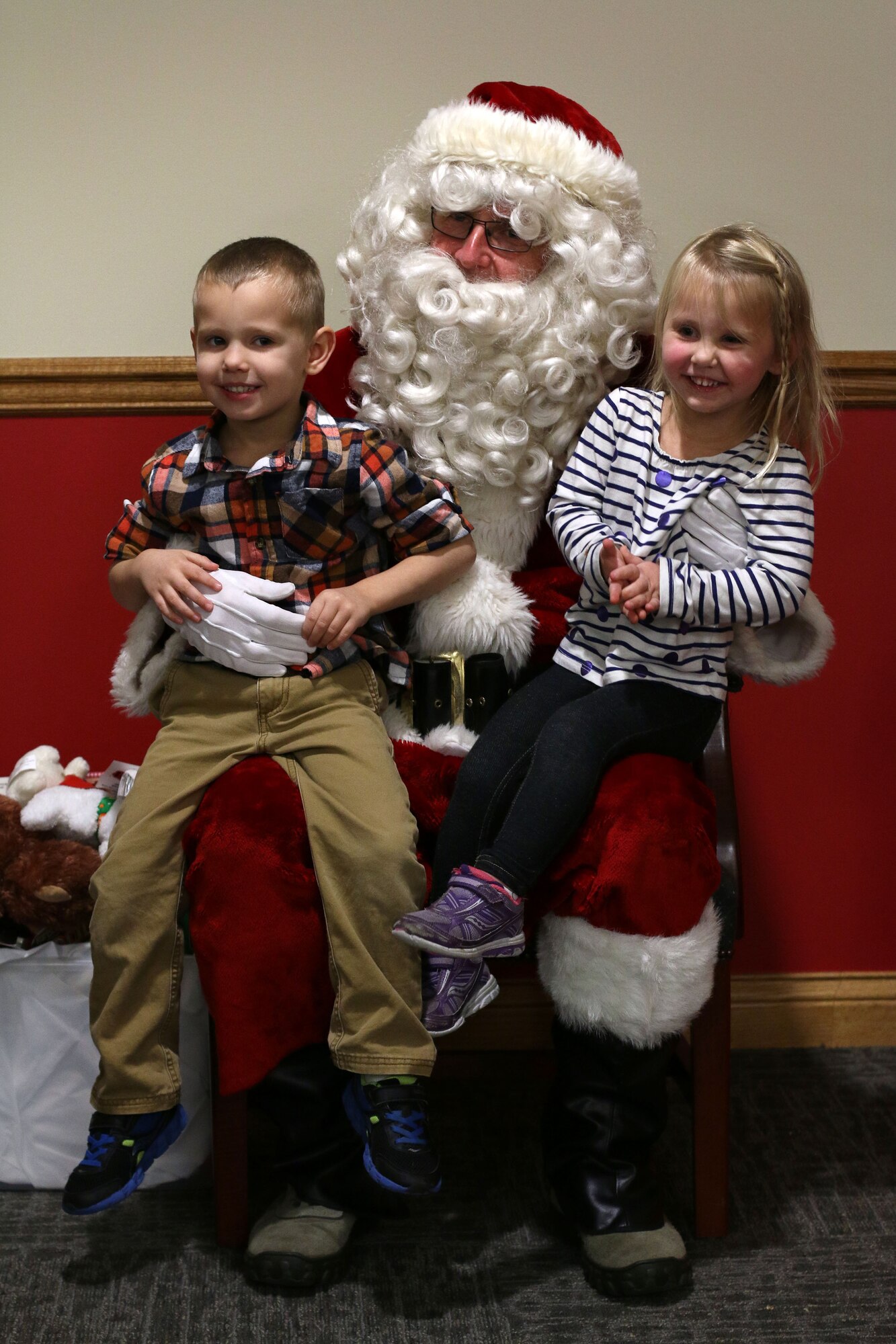 Santa Claus (played by Lt. Col. Alan Kendrick, 445th Airlift Wing performance manager) listened to Christmas wishes from children of the 445th Airlift Wing staff during the wing's annual Christmas party December 4, 2016. (U.S. Air Force photo/Tech. Sgt. Patrick O'Reilly) 