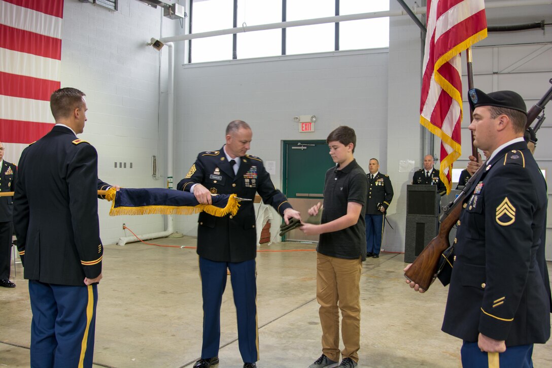 LANCASTER, Pa. - The 3rd Battalion 319th Regiment Command Sgt. Maj. David W. Hausler (left) received help casing the Battalion colors, from his son David Hausler Jr. (right), during the unit’s deactivation ceremony held here on Dec. 17, 2016. The ceremony marks the closing of the unit as part of a larger restructuring of the 800th Logistics Support Brigade, headquartered in Mustang, Oklahoma.