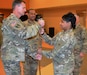 Col. Toni A. Glover, 650th Regional Support Group commander, passes the noncommissioned officer sword, which is used to signify the transfer of responsibility, to Command Sgt. Maj. Darin S. Daniels, a Mesa, Arizona resident, in a change of responsibility ceremony at the George W. Dunaway Army Reserve Center in Sloan, Nevada December 18. In his civilian capacity, Daniels serves as a Firefighter/Paramedic on the Phoenix Fire Department.