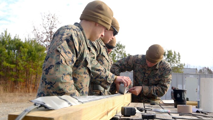 Marines craft together a detonation cord linear charge for an urban assault breaching range during a deployment for training exercise at Fort Pickett, Va., Dec. 8, 2016. The training gave the Marines an opportunity to practice making and applying donut charges, oval charges and uli knot slider charges. The Marines are with Lima Company, 3rd Battalion, 8th Marine Regiment. 