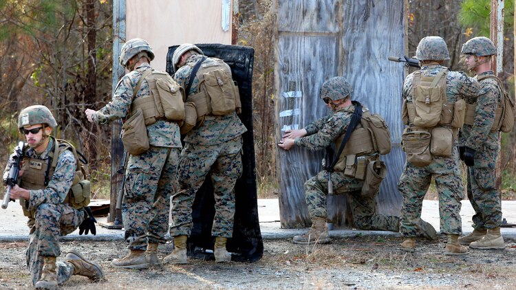 Marines place a detonation cord linear charge on a door for an urban assault breaching range during a deployment for training exercise at Fort Pickett, Va., Dec. 8, 2016. The purpose of the training was to prepare the Marines for real-world scenarios in assault breaching. The Marines are with Charlie Company, 2nd Combat Engineer Battalion. 