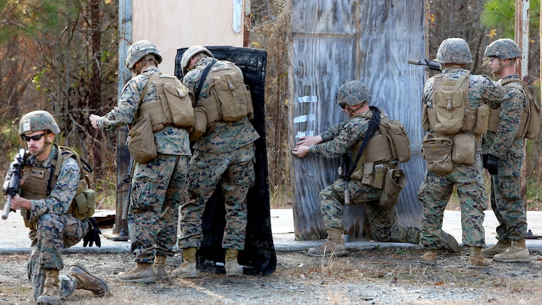 Marines place a detonation cord linear charge on a door for an urban assault breaching range during a deployment for training exercise at Fort Pickett, Va., Dec. 8, 2016. The purpose of the training was to prepare the Marines for real-world scenarios in assault breaching. The Marines are with Charlie Company, 2nd Combat Engineer Battalion. 