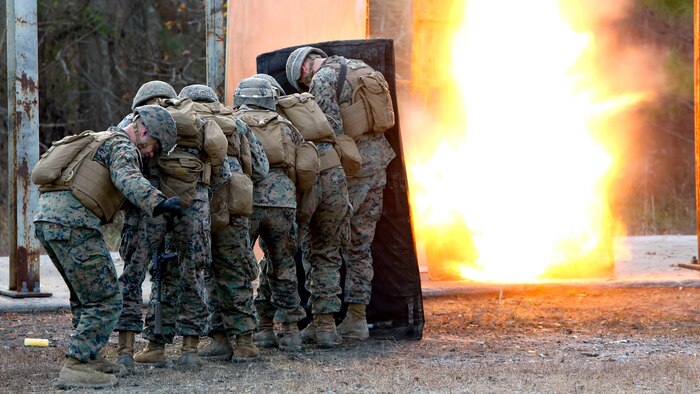 Marines take cover while setting off a detonation cord linear charge for an urban assault breaching range during a deployment for training exercise at Fort Pickett, Va., Dec. 8, 2016. The range was an opportunity for the Marines to practice the fundamentals of their job in an assault breaching. The Marines are with Charlie Company, 2nd Combat Engineer Battalion. 