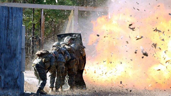 Marines take cover while setting off a detonation cord linear charge for an urban assault breaching range during a deployment for training exercise at Fort Pickett, Va., Dec. 8, 2016. The range was an opportunity for the Marines to practice the fundamentals of their job in an assault breaching. The Marines are with Charlie Company, 2nd Combat Engineer Battalion. 