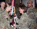 Command Sgt. Maj. Jody L. Stanley (center), incoming command sergeant major for the 232nd Medical Battalion at Joint Base San Antonio-Fort Sam Houston, accepts the guidon from Lt. Col. Caryn R. Vernon (left), 232d Med. Bn. commander, while outgoing battalion Command Sgt. Maj. Richard A. Shanklin (right) looks on. The battalion is the largest training battalion in the U.S. Army, responsible for training Health Care Specialist, 68W, the second largest Military Operational Specialty in the U.S. Army.