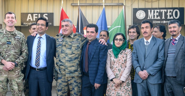 Members of NATO Air Command - Afghanistan and the Afghan Civil Aviation Authority stand together during a group photo at Hamid Karzai International Airport, Kabul, Afghanistan, Jan. 1, 2017. The military and civilian aviation personnel held a ceremony which marked the integration of Afghan meteorologists into the NATO meteorology office at the busiest airport in Afghanistan. (NATO photo by Kay M. Nissen)