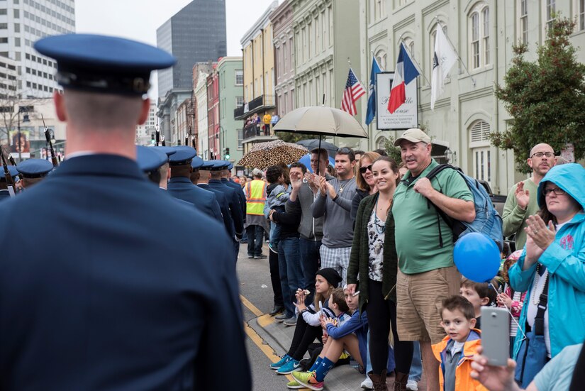 Allstate Sugar Bowl New Years Eve Parade attendees clap and cheer as the U.S. Air Force Honor Guard marches in front of them in New Orleans, LA., Dec. 31, 2016. The parade consisted of floats, bands, marching units and other performers to entertain fans prior to the Allstate Sugar Bowl between the Auburn Tigers and Oklahoma Sooners on Jan. 2, 2017. 