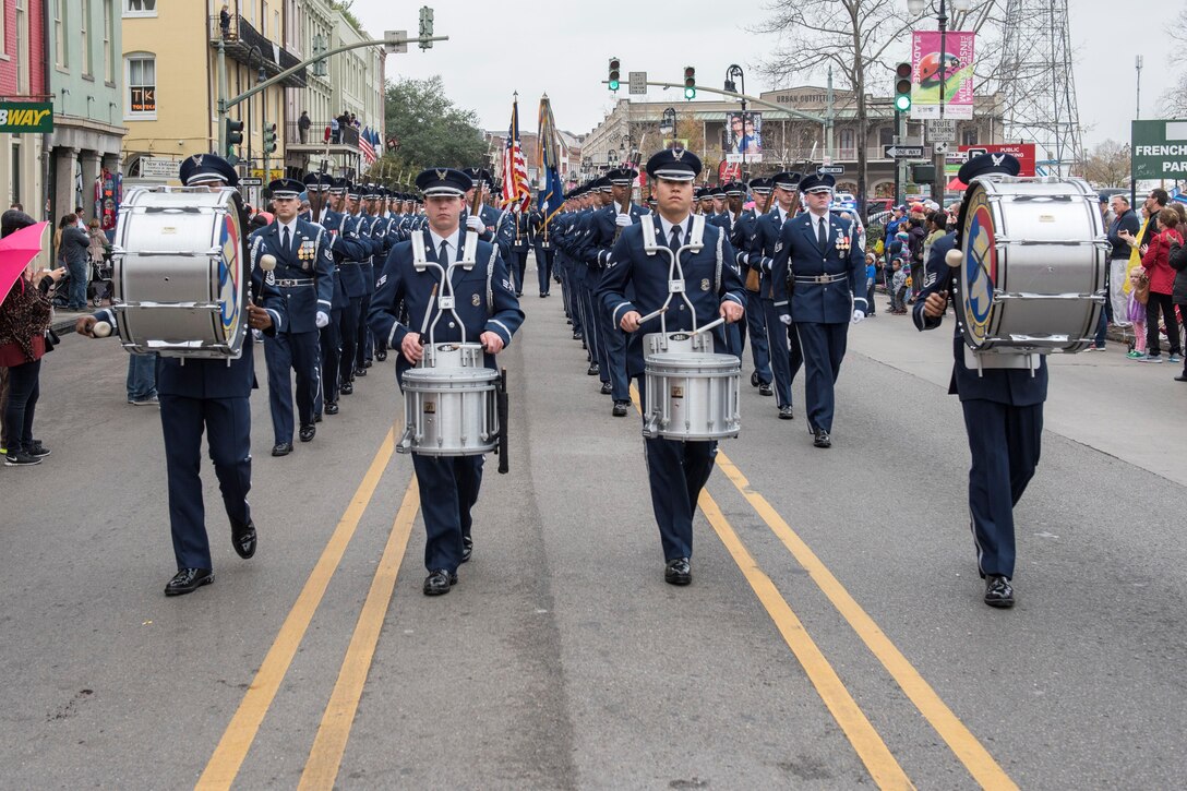 Members of the U.S. Air Force Honor Guard march down a crowd-filled street during the Allstate Sugar Bowl New Years Eve Parade in New Orleans, LA, Dec. 31, 2016.  The event is part of the Allstate Sugar Bowl celebration that leads to the game between the Auburn Tigers and Oklahoma Sooners on Jan. 2., 2017.