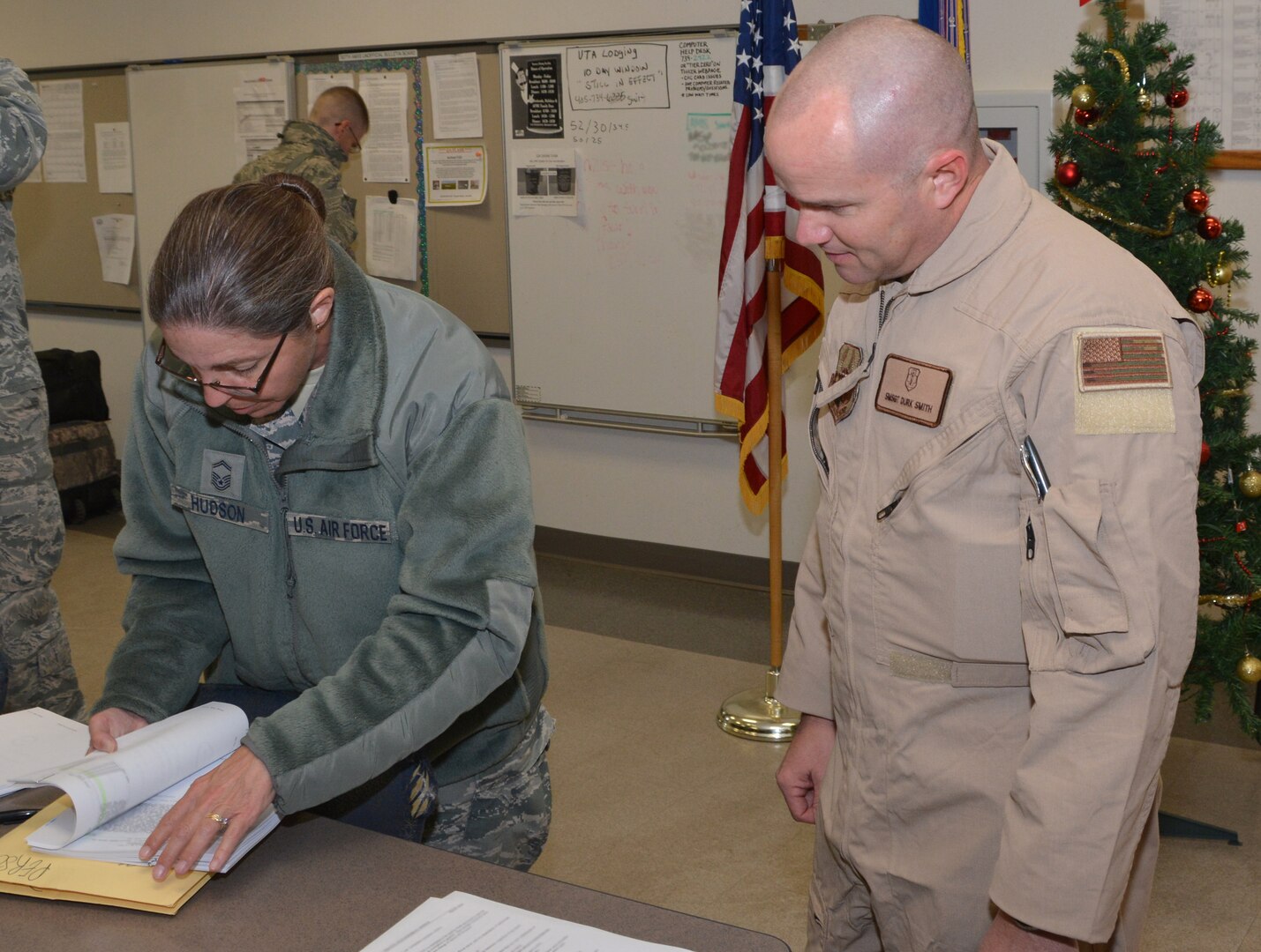 Senior Master Sgt. Durk Smith, a medical flight technician assigned to the 465th Air Refueling Squadron has his deployment orders reviewed prior to deploying by Senior Master Sgt. Julie Hudson, 507th Logistics Readiness Squadron distribution flight superintendent at Tinker Air Force Base, Oklahoma, December 12, 2016. (This image was blurred for operational security/U.S. Air Force Photo/Tech. Sgt. Lauren Gleason)