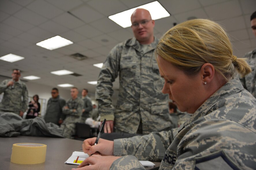 Master Sgt. Angela Vereb, 507th Maintenance Group unit deployment manager scrubs the deployment folder of Staff Sgt. Coty Carter, 507th Aircraft Maintenance Squadron prior to him deploying to Incirlik Air Base, Turkey to support air refueling operations in Southwest Asia December 13, 2016. (U.S. Air Force Photo/Maj. Jon Quinlan)