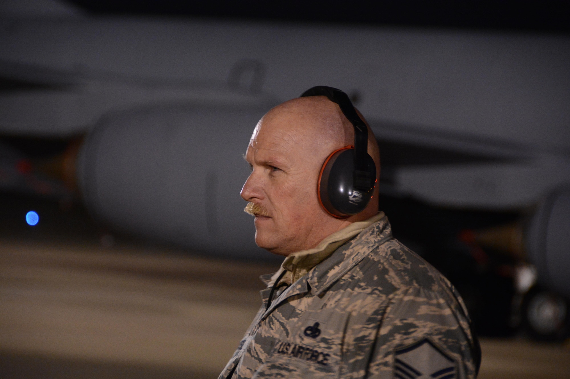Master Sgt. Jon Russell, 507th Maintenance Squadron Aerospace Group Equipment flight chief, supervises ground operations while two KC-135R Stratotankers packed with cargo and some of the 94 Citizen Airmen launch during a cold December 13th evening at Tinker Air Force Base, Oklahoma.  The two jets deployed to Incirlik Air Base, Turkey to support on-going air refueling operations in Southwest Asia.  (U.S. Air Force Photo/Maj. Jon Quinlan)