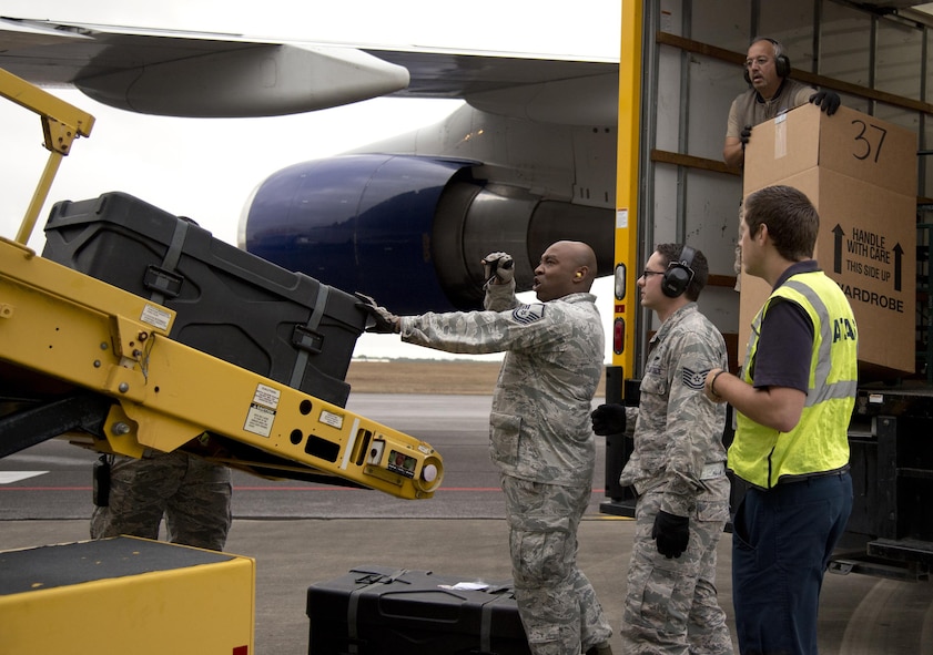 The 96th Logistics Readiness Squadron's non-flying loadmasters load the Niceville High School band’s musical equipment Dec. 29 on the flight line at Eglin Air Force Base, Fla. The Airmen also known as ‘port dogs’ loaded more than 800 pieces of equipment and luggage for the Niceville High School band for their performance in the 2017 Tournament of Roses Parade in California. (U.S. Air Force photo/Kristin Stewart)