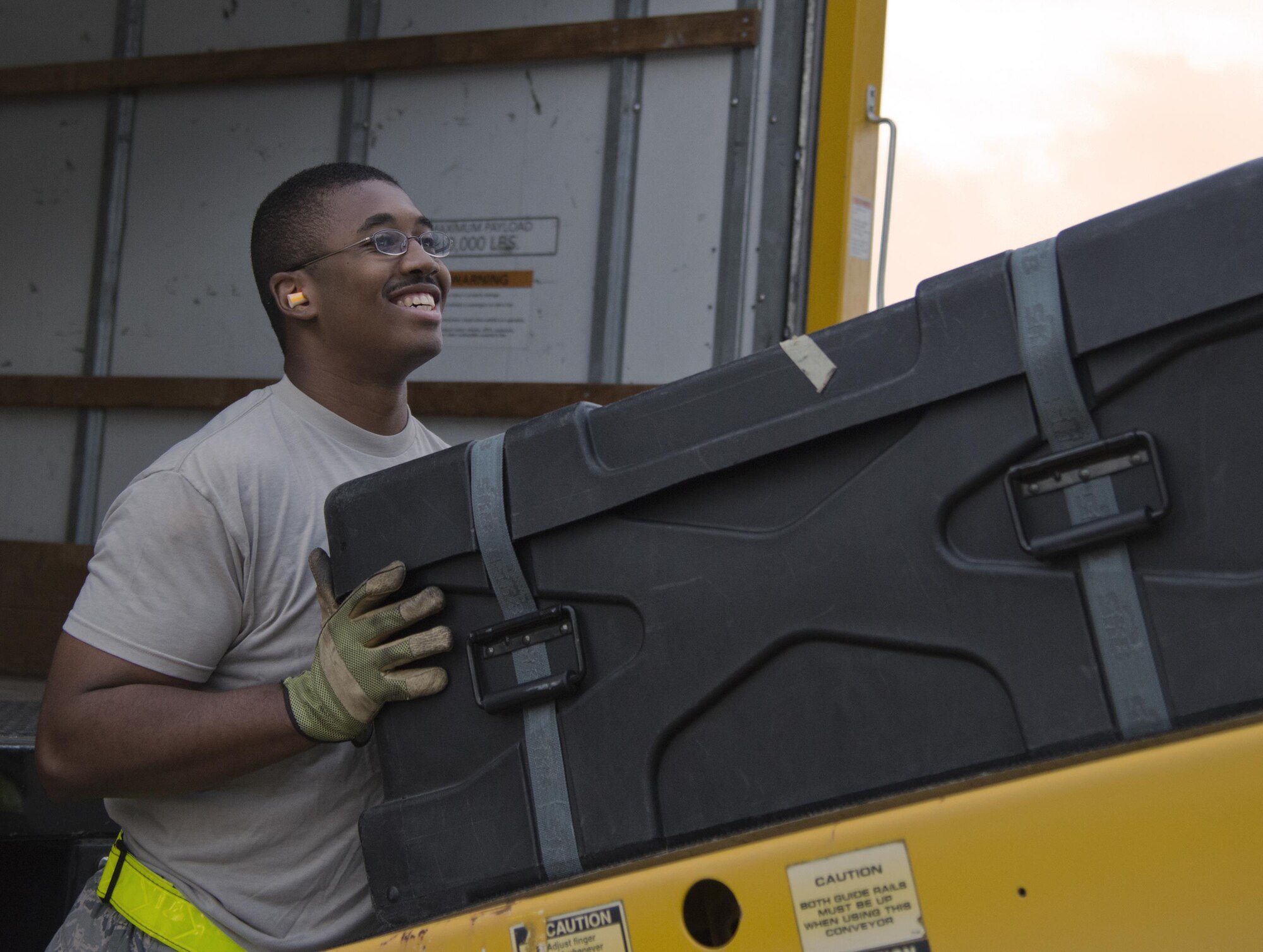 Staff Sgt. Jamal Johnson, air transportation journeyman, 96th Logistics Readiness Squadron guides equipment into the loading bay Dec. 29 on the flight line at Eglin Air Force Base, Fla. The non-flying loadmasters are responsible for the movement of passengers and cargo at Eglin. The equipment belonged to the Niceville High School band students and staff members for their performance in the 2017 Tournament of Roses Parade in California. (U.S. Air Force photo/Kristin Stewart)