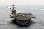 In this file photo, ships of the Carl Vinson Strike Group steam in formation during pre-deployment training in August. 