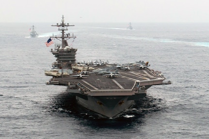 In this file photo, ships of the Carl Vinson Strike Group steam in formation during pre-deployment training in August. 